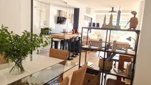a living room with a table and chairs at Aires de Doñana. Piscina y Playa. Parking gratis. in Sanlúcar de Barrameda