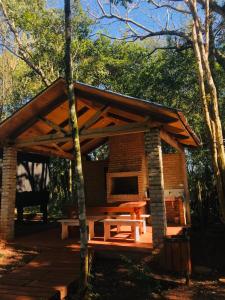 a cabin with a picnic table in the woods at Cabañas El Portal in Jardín América