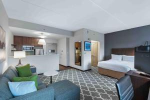 a hotel room with a bed and a living room at Residence Inn by Marriott Atlanta Covington in Covington