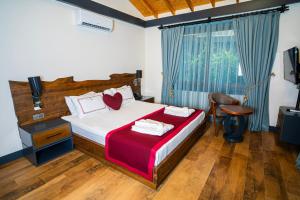 A bed or beds in a room at Porto Amore Club Hotel