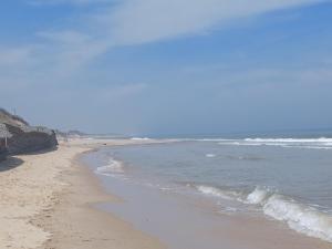 a sandy beach with the ocean in the background at Holiday at Hemsby in Hemsby