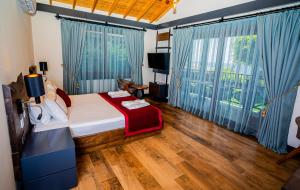 A bed or beds in a room at Porto Amore Club Hotel