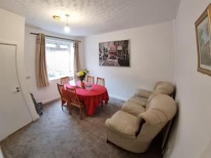 a dining room with a table and chairs at 4 Bedroom House in Central Rochdale cul-de-sac Free Parking & Fast Wi-Fi in Rochdale