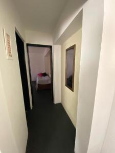 pasillo que conduce a un dormitorio con cama en Hospedaje en Merlo, en Merlo