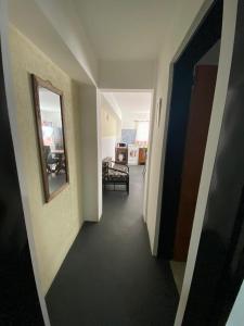 pasillo que conduce a una sala de estar con espejo en Hospedaje en Merlo, en Merlo 2 fotos más