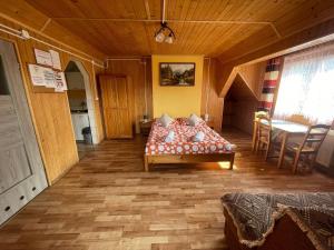 a bedroom with a bed in the middle of a room at Przystanek Wetlina in Wetlina