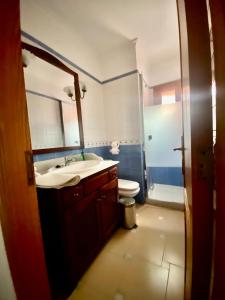 a bathroom with a sink and a toilet and a mirror at Puerto de Pollensa cat Villas in Port de Pollensa