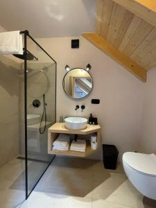 a bathroom with a sink and a mirror at Penzion Kolnička in Luka nad Jihlavou