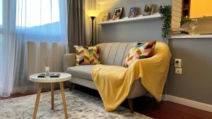 a living room with a couch and a table at Divine Studio Fermei 62 in Popeşti-Leordeni +18 photos