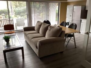 a living room with a couch and a table at Garden room B in West Vancouver