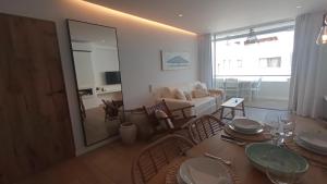 a dining room and living room with a table and chairs at El Balcón de Formentera in La Savina