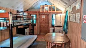 a room with two bunk beds and a table at Abrams Creek Campground in Mount Storm