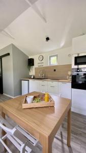 a kitchen with a table with a bowl of food on it at Petite maison dans la prairie in Marmeaux