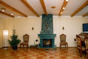 a living room with a fireplace and chairs at BASH Village House in Ventspils