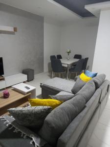 a living room with a couch with pillows on it at IN LUX Apartment Skopje 