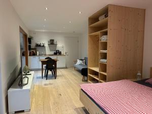 a bedroom with a bed and a desk and a kitchen at Schlossquelle Königsdorf in Königsdorf