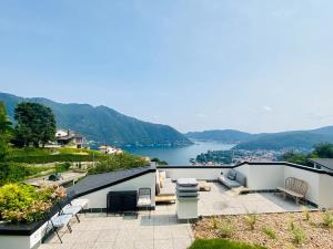 a patio with a view of a body of water at Como Lake Dreamscape Villa in Cernobbio