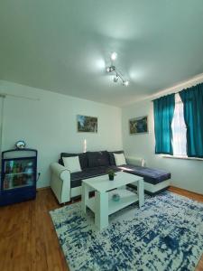 a living room with a couch and a table at Sarajevo Central View Apartment in Sarajevo