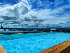 a large swimming pool on top of a building at Wally Residence in Rimini