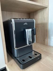 a black toaster oven sitting on top of a shelf at Meet & Golf in Šajdíkove Humence