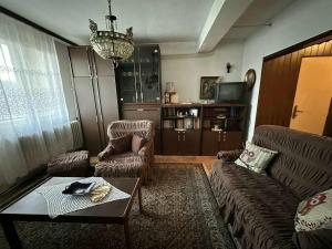 a living room with a couch and chairs and a table at Apartment Centar in Prokuplje