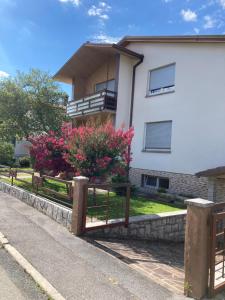 a house with a fence in front of it at 7 Flower Street Apartment in Šempeter pri Gorici