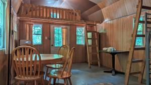 a dining room with a table and chairs and a bunk bed at Abrams Creek Campground in Mount Storm
