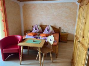 a bedroom with a bed and a table and a table at Haus Ranner in Bad Mitterndorf