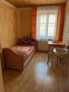 1 dormitorio con cama, lavabo y ventana en Haus Ranner, en Bad Mitterndorf