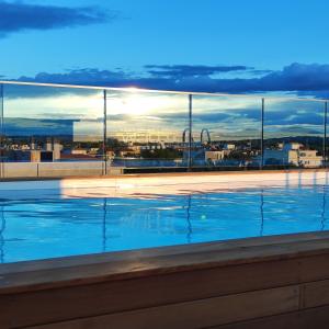 a swimming pool with a view of a city at Wally Residence in Rimini