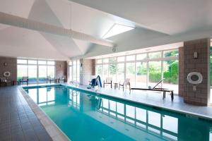 a large swimming pool in a building at Courtyard Rochester East / Penfield in Rochester