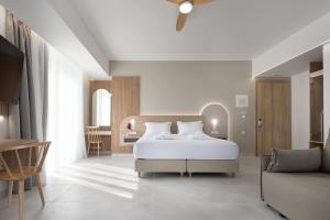 a bedroom with a bed and a living room at Epavli Grace Hotel in Chania Town