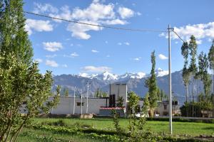 a view of a building with mountains in the background at Kushu Guest House in Leh