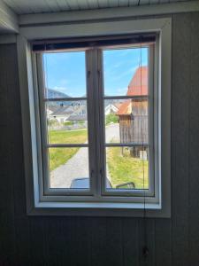 a window in a room with a view of a yard at Øyfoss overnatting in Fyresdal