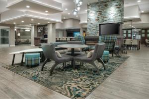 a lobby with a table and chairs and a tv at Residence Inn by Marriott Decatur Emory Area in Decatur