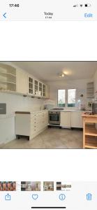 a kitchen with white cabinets and a stove top oven at La grande bellezza in Martinšćica +33 photos