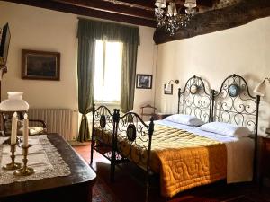 a bedroom with a bed and a table and a window at B&B Corte Seguini in Bagnatica