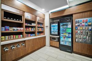 a grocery store aisle with a refrigerator and drinks at SpringHill Suites by Marriott Phoenix Goodyear in Goodyear