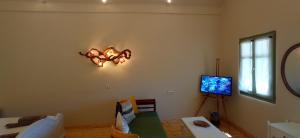 a living room with a chandelier on the wall at Aliori art caves in Aegiali