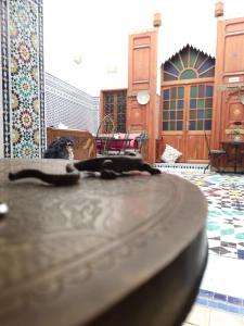 a dog is sitting on a table in a mosque at Riad Fes Touria Palace in Fez