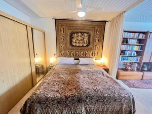 a bedroom with a large bed with a headboard at Ferienwohnung Brigitte in Füssen +15 photos