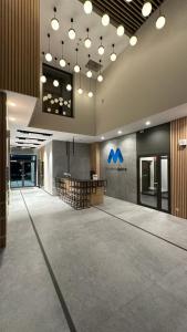 a large lobby with a reception desk in a building at Warsaw Home Suites in Warsaw