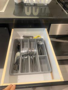 a tray of utensils in a drawer in an appliance at Квартира студия Damac Maison Cour Jardin in Dubai