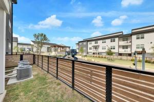 a deck with a fence in front of a building at Charming 1 BR Austin Oasis-Perfect for your vacation! in Kyle