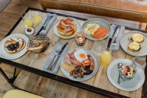 a table with plates of breakfast food on it at The Bonnie Badger in Gullane