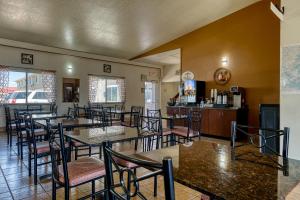 a restaurant with tables and chairs and a bar at Super 8 by Wyndham Alamosa in Alamosa