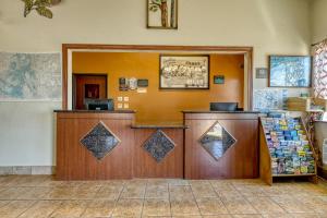 a waiting room with a cash register and a counter at Super 8 by Wyndham Alamosa in Alamosa