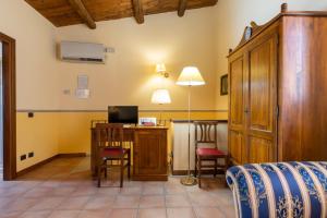 1 dormitorio con 1 cama y escritorio con ordenador en Hotel Il Barocco, en Ragusa