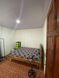 ein Schlafzimmer mit einem Bett in der Ecke eines Zimmers in der Unterkunft Casa de campo entera rodeada de naturaleza en Sarapiquí in Heredia