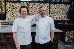 two men standing next to each other in a kitchen at The Bonnie Badger in Gullane